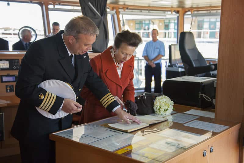 HRH The Princess Royal signing the visitors book aboard RRS Discovery