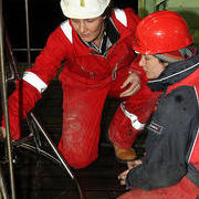 Rachel Mills and Clare Woulds examining the black mud collected by the megacorer