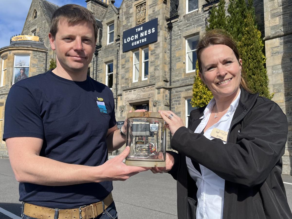 Sam Smith, ALR operations engineer, hands the camera system to Emma Barnacle, Duty Manager at The Loch Ness Centre.