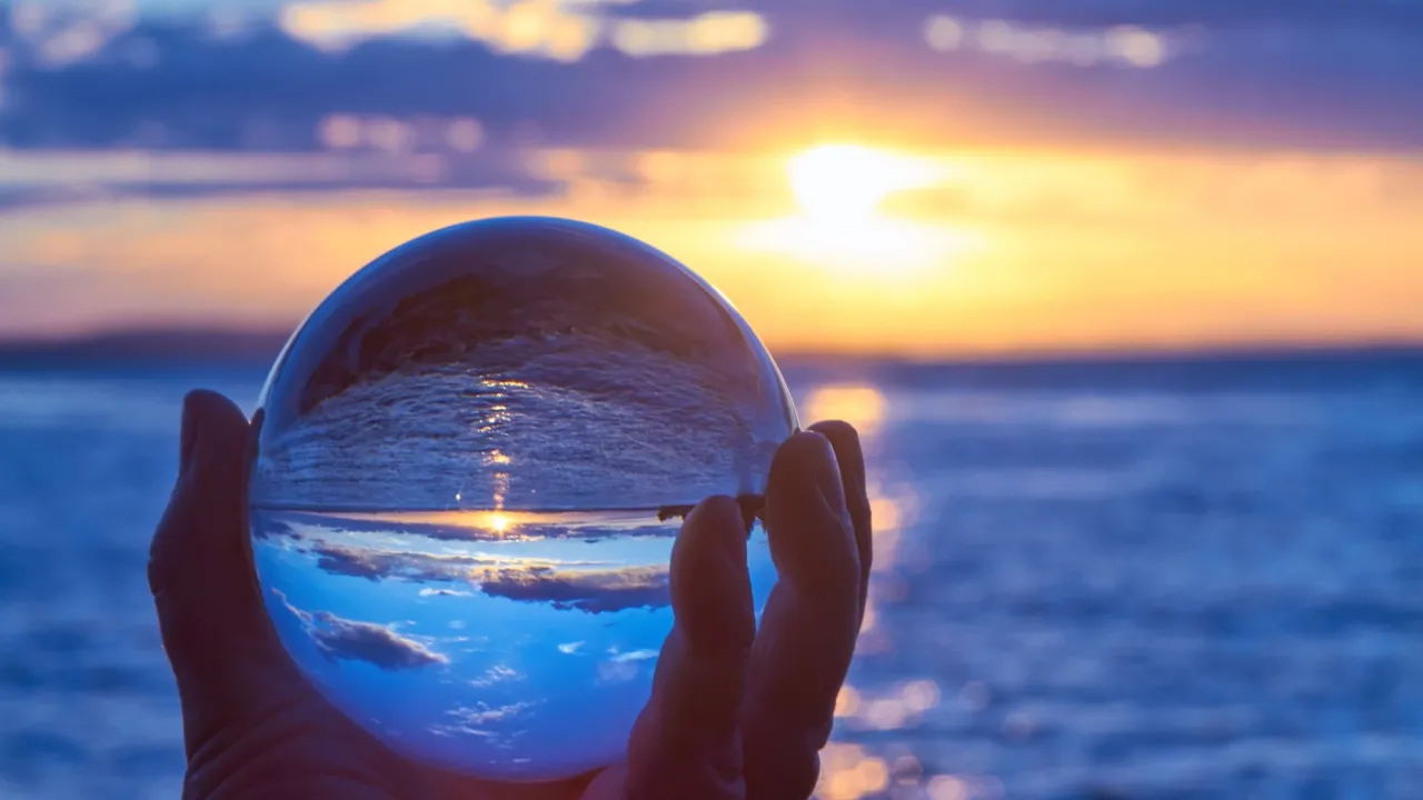 Glass orb reflecting the ocean behind