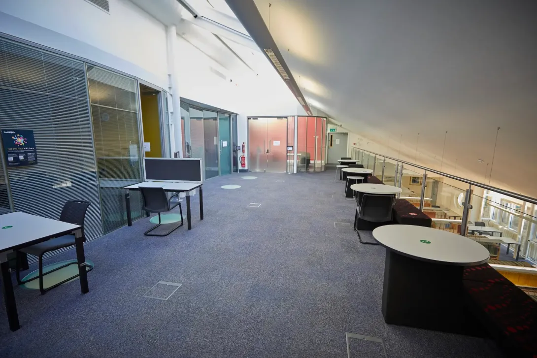 Library mezzanine floor with meeting rooms and modular work spaces