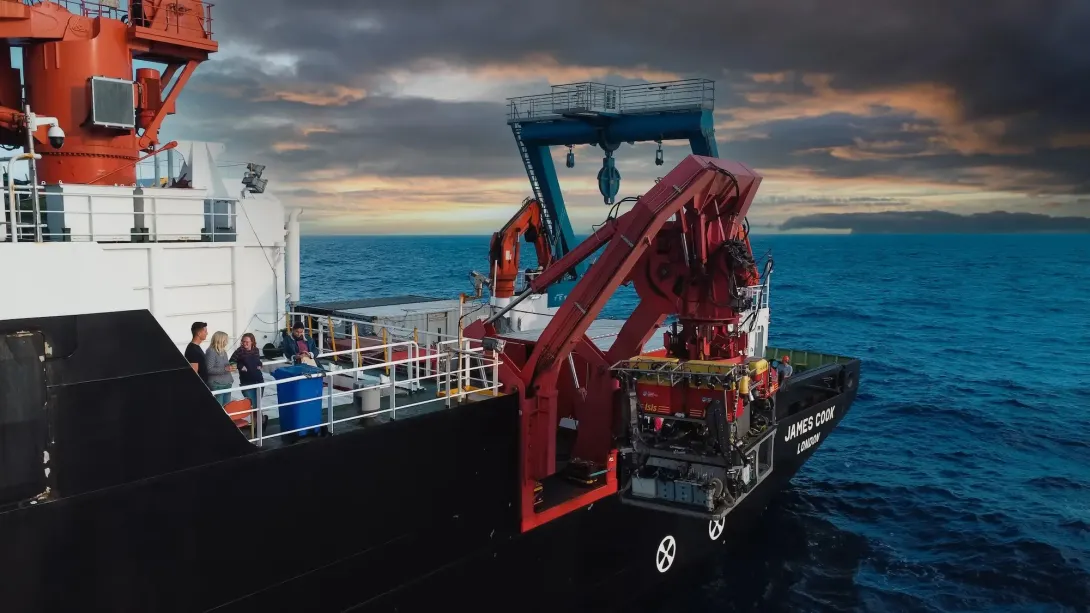 Remotely Operated Vehicle being deployed with crew watching