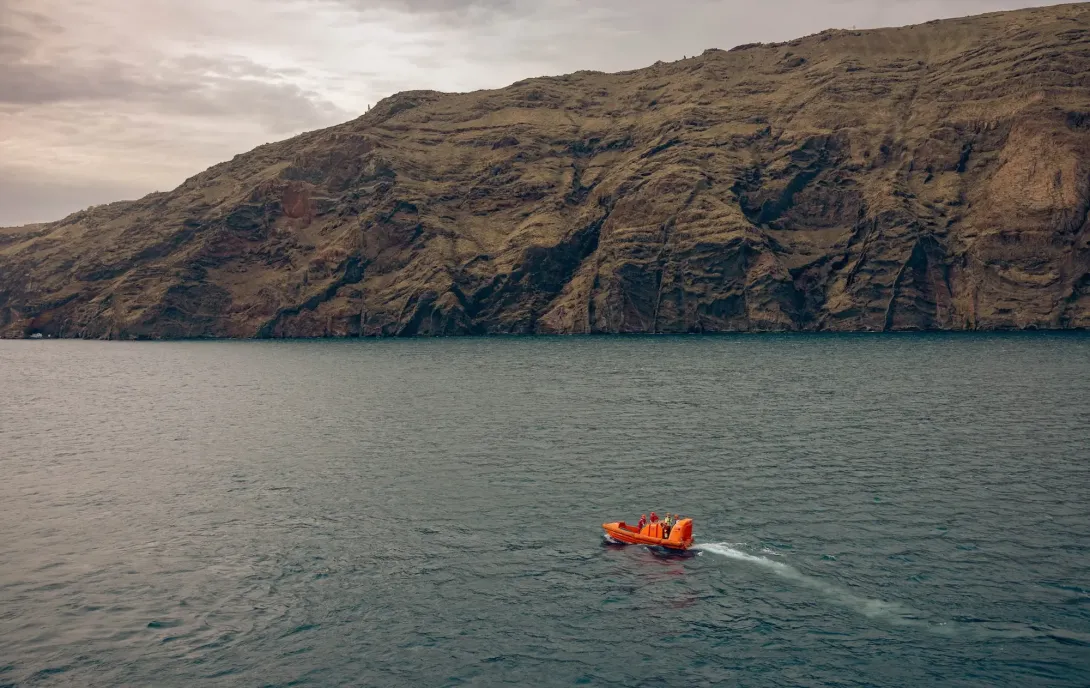 Support vessel leaving RRS Discovery in Santorini, Greece