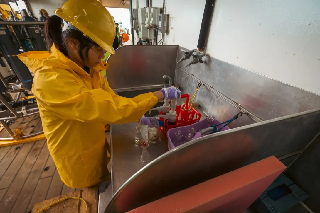 Sample bottles being examined by a scientist