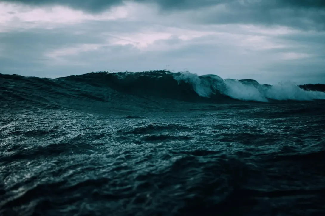 Dark blue wave on a stormy overcast day